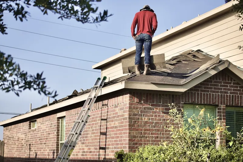 Professional roofer working on a residential roof in New Alexandria